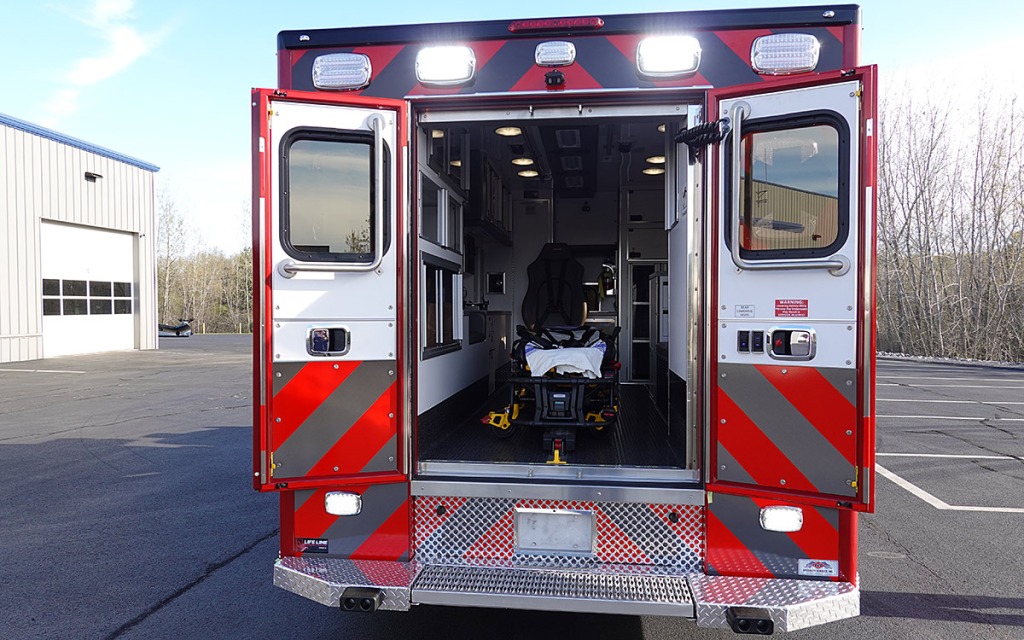 Back doors are open to the patient care area.